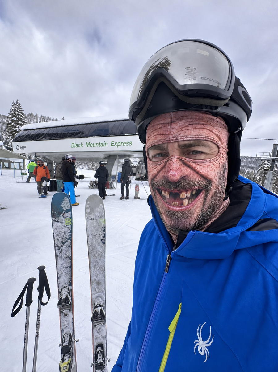 Skier wearing a printed ski mask beside the ski lift